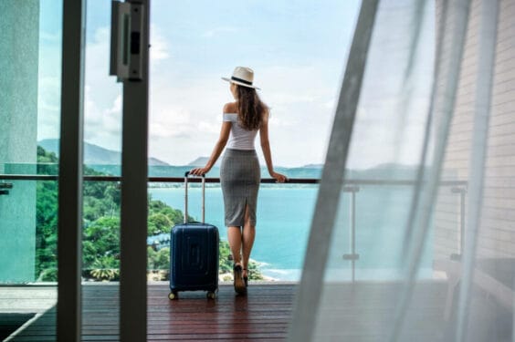 Back View Beautiful Tourist With Luxurious Figure Hat Poses With Her Luggage Balcony Which Offers Beautiful View Sea Mountains Travel Vacation 1 1024x682 Back View Beautiful Tourist With Luxurious Figure Hat Poses With Her Luggage Balcony Which Offers Beautiful View Sea Mountains Travel Vacation 1 1024x682