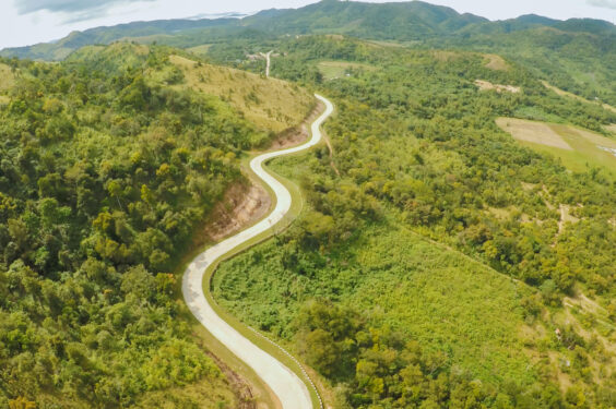 A,long,and,winding,road,passing,through,green,hills.,busuanga A,long,and,winding,road,passing,through,green,hills.,busuanga